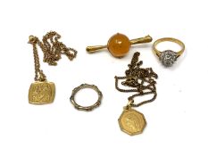 Two religious pendants on chains, dress ring,