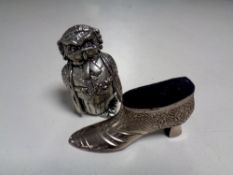 A pin cushion in the form of a shoe together with one other