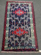 A Baluchi rug 140cm by 81cm