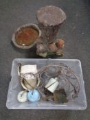 A concrete garden bird bath together with a box containing hanging basket,