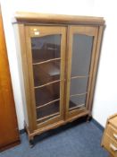 A continental glazed mahogany double door bookcase
