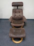 A relaxer armchair with matching footstool in brown suede upholstery on pine effect base