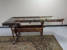 A 20th century wooden work bench fitted a vice