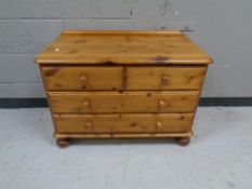 A contemporary pine four drawer low chest