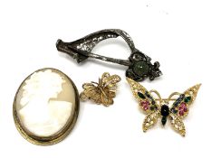 Four costume brooches to include cameo,