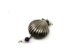 A silver shell locket