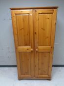 A contemporary pine double door wardrobe