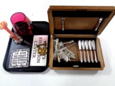 A tray containing canteen of Flex-Fit cutlery, cast iron plaques,