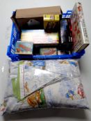 A crate containing boxed clockwork toys, a Beatrix Potter volume,