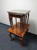A nest of three tables with tooled leather inset panels together with a further contemporary lamp