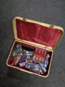 A vintage case of a large quantity of souvenir teaspoons