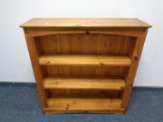 A set of pine open bookshelves.