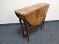 A 19th century walnut drop leaf occasional table.
