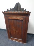 A George III inlaid oak corner cabinet