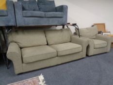 A contemporary settee and armchair upholstered in a brown fabric.