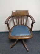 An Edwardian oak desk armchair