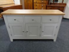 A contemporary oak topped triple door sideboard
