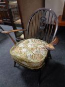 An Ercol elm and beech armchair in antique finish