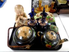 A tray containing miscellany to include German bisque figure of a baby eating chocolate,