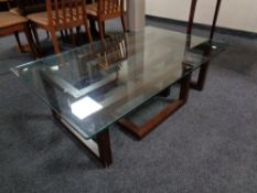 A contemporary glass topped coffee table