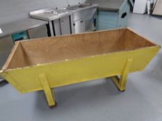 A 19th century pine dough box on metal castors.