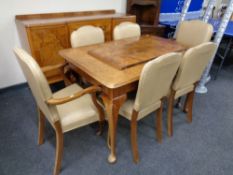 An eight piece walnut Queen Anne dining room suite comprising of inverted breakfront sideboard,