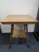 An Edwardian oak occasional table.