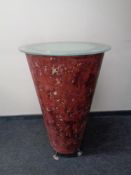 A conical poser bar table with glass top.