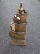 An antique cast iron companion stand with companion pieces in the form of a galleon