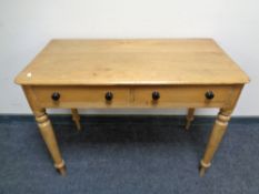 A Victorian pine side table fitted with two drawers