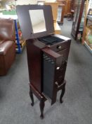 A Thomas Paccone jewellery chest on raised legs