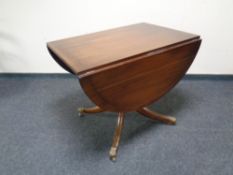 A Regency style inlaid mahogany drop leaf pedestal table