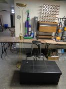 A set of three black vinyl stools on metal legs together with a folding faux leather blanket box