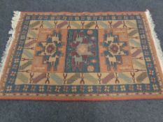 A machine made fringed rug of geometric design