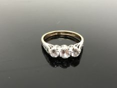 A 9ct gold synthetic sapphire three stone ring,