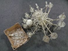 A decorative wrought iron 12 branch chandelier with glass drops