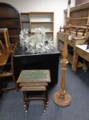 An early 20th century carved beech standard lamp together with a nest of three leather topped