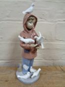 A Lladro figure of a Boy feeding birds together with a Border Fine Arts figure depicting a fox