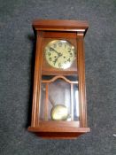 An Edwardian oak wall clock