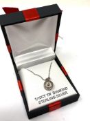 A silver diamond set pendant.