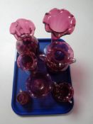 A tray containing seven pieces of antique and later cranberry glassware