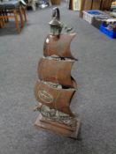 An antique cast iron and copper companion set on stand in the form of a galleon