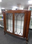 An Edwardian mahogany double door display cabinet on claw and ball feet