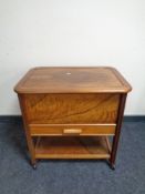 A mid 20th century walnut sewing trolley
