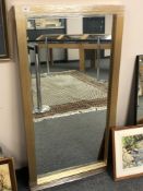 A contemporary bevelled mirror in a golden frame,