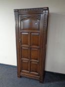 An Edwardian carved oak hall wardrobe