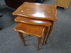 A nest of three yew wood tables