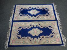 Two Chinese fringed rugs on blue ground