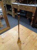 A brass Art Deco fire poker on stand