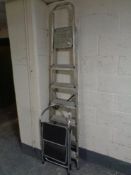 A set of folding aluminum steps together with a set of stool steps